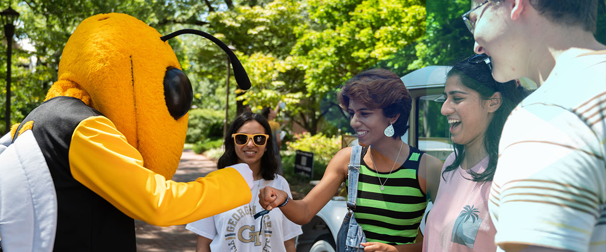 Students fistbumping Buzz on campus