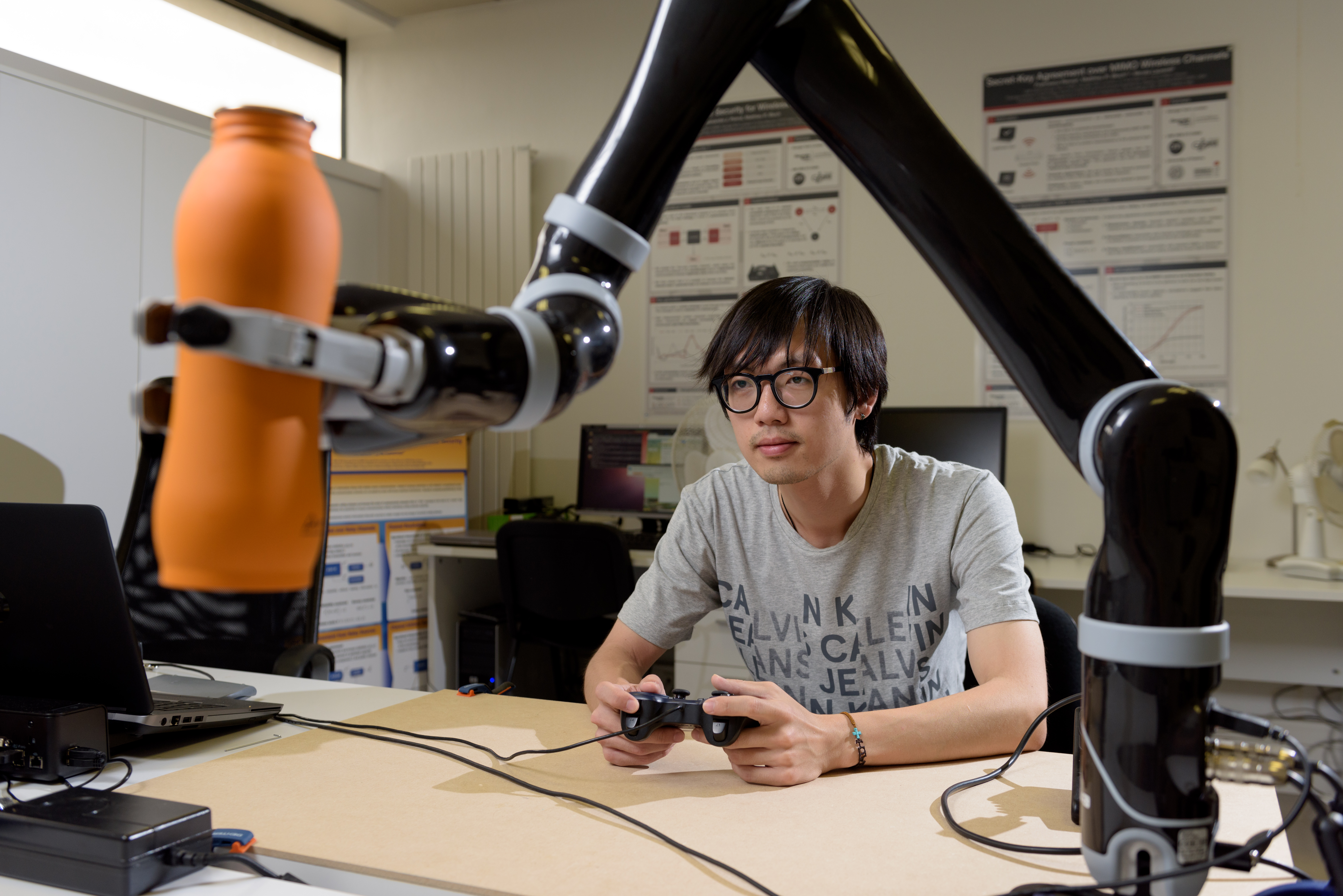 Student controlling a robot arm 