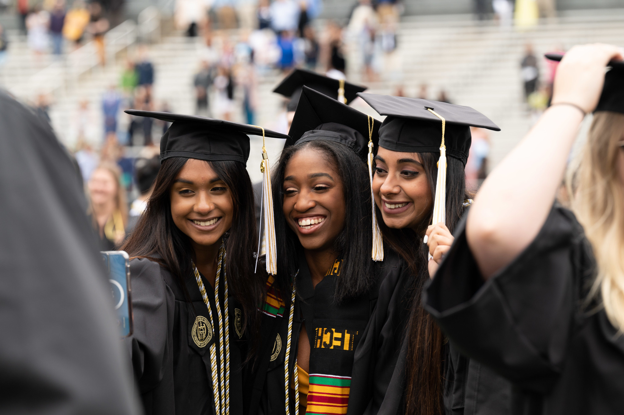 Three female graduates taking a selfie.