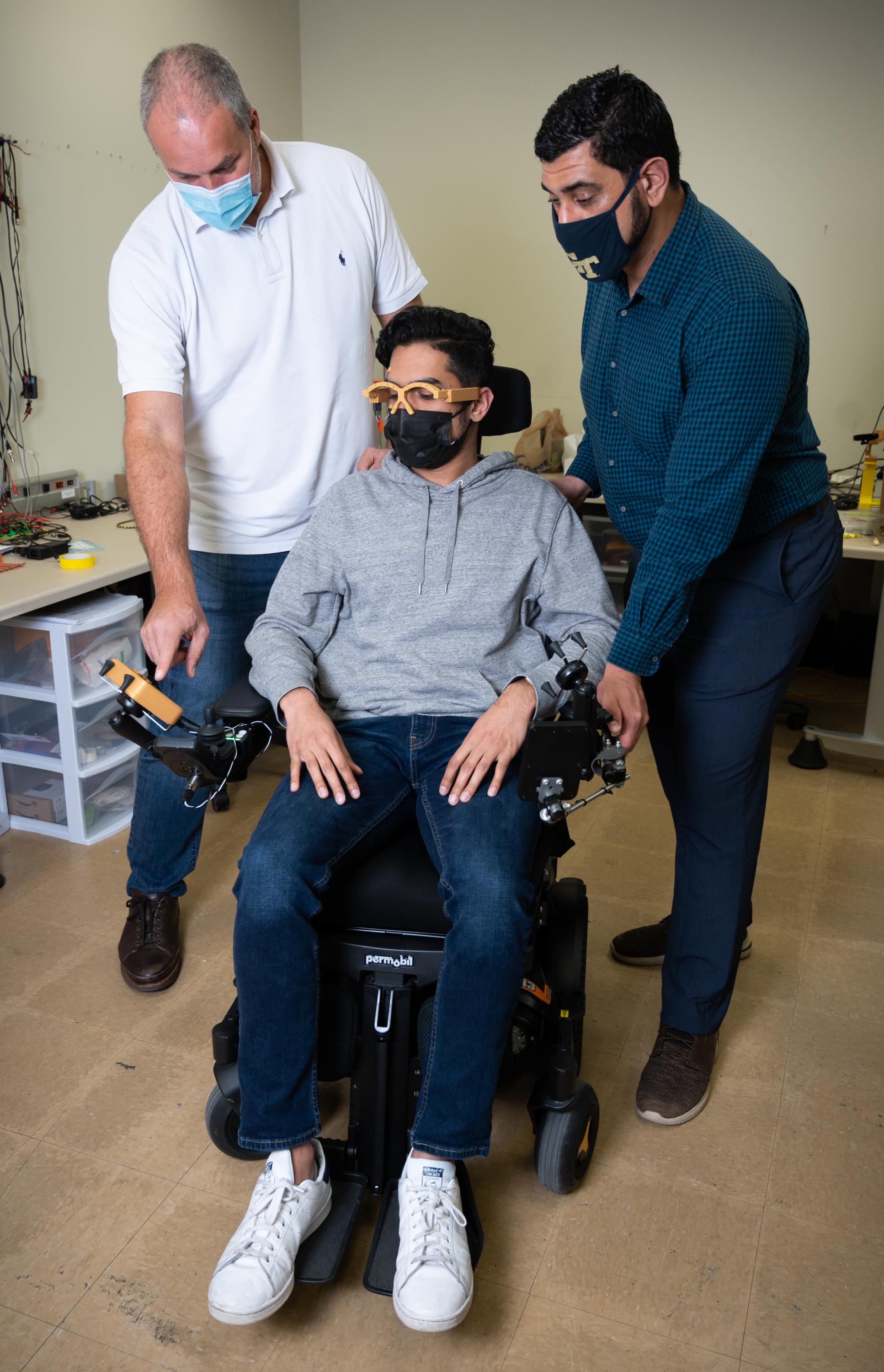 Researcher testing MagTrack on man with paralysis