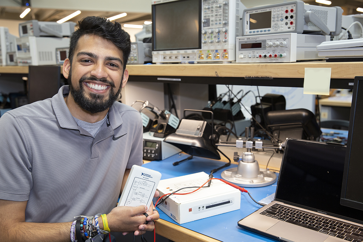 Rohan Sohani, president of Tech’s Student Government Association, displays a myDAQ instrumentation device — a required piece of equipment for some ECE courses. Through ECE Cares, Georgia Tech students can now check out a myDAQ from the library — avoiding the cost of the more than $300 device.